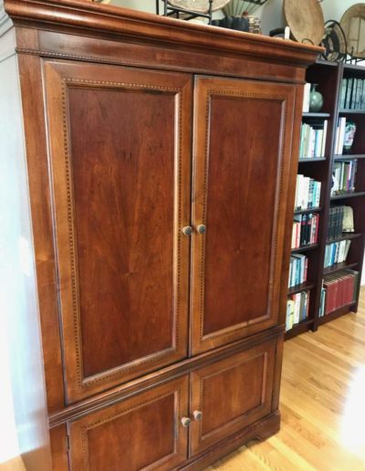 Dumbwaiter tucked into the wooden cabinet (doors closed)