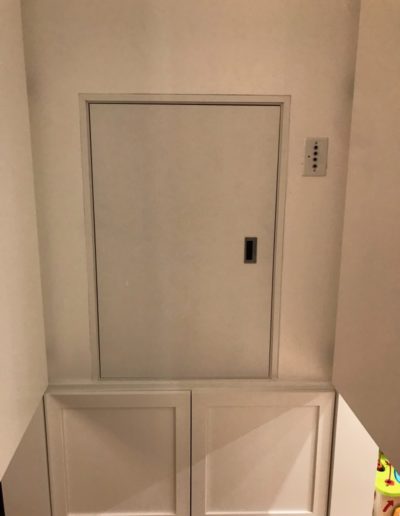 residential dumbwaiter with the white panels open to show the dumbwaiter