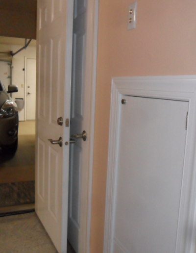 dumbwaiter car with the door closed near the garage makes it easy to get groceries up from the car to the kitchen