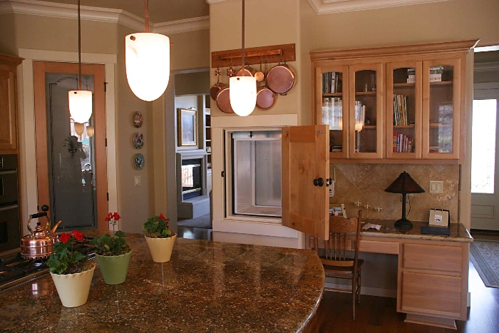 powerlift dumbwaiter in a kitchen neatly tucked below the pans