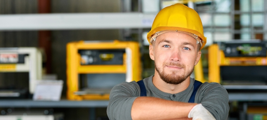 The smiling face of a man with a hard hat on who is ready to help our dumbwaiter customers as soon as they contact us