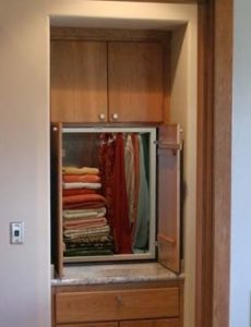 A residential dumbwaiter being used to get laundry up from the laundry room