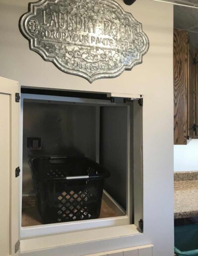 home dumbwaiter with a laundry basket in it.